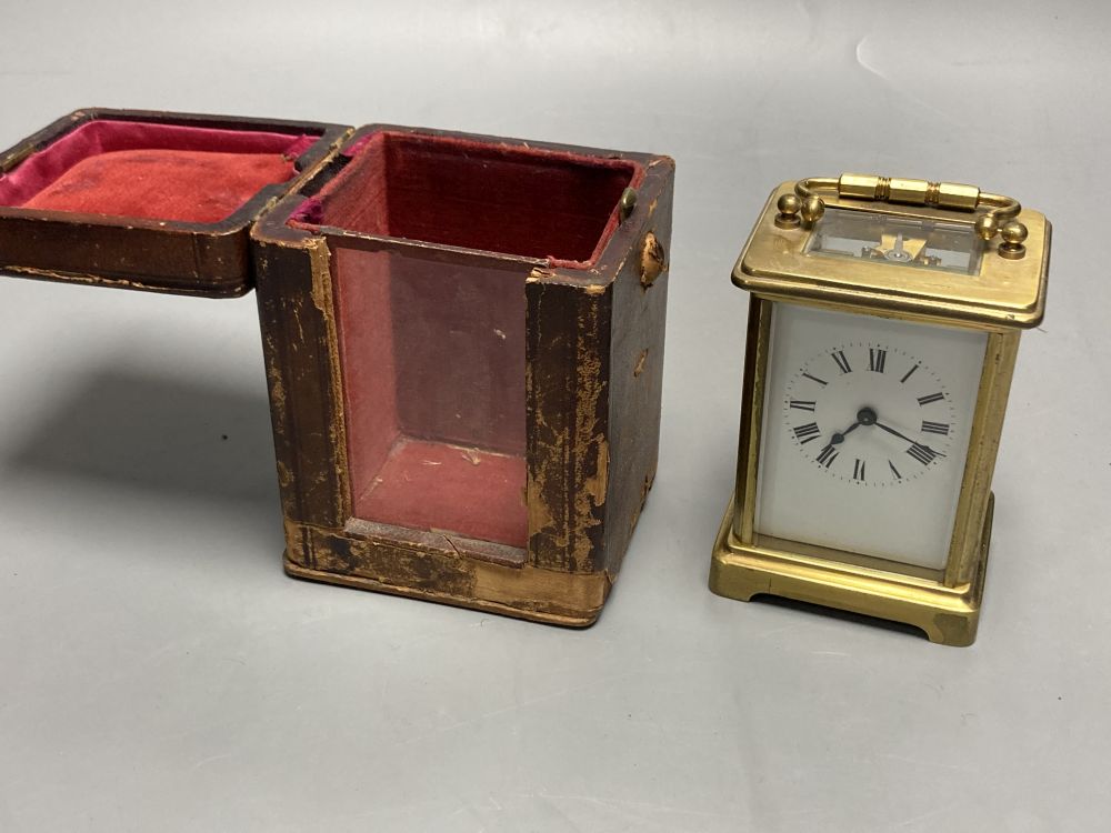 A gilt-brass carriage timepiece, with white enamelled Roman dial and outer travelling case and another carriage clock (2)